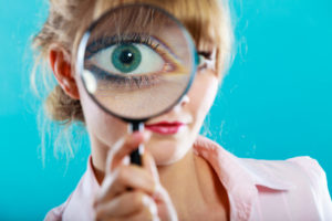 Investigation exploration education concept. Closeup funny woman face, girl holding on eye magnifying glass loupe