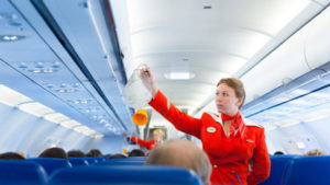 44088939 - moscow - may 28, 2011: air hostess yulia of aeroflot shows how to use an oxygen mask on board. aeroflot operates the youngest fleet in the world among major airlines, numbering 150 airliners.